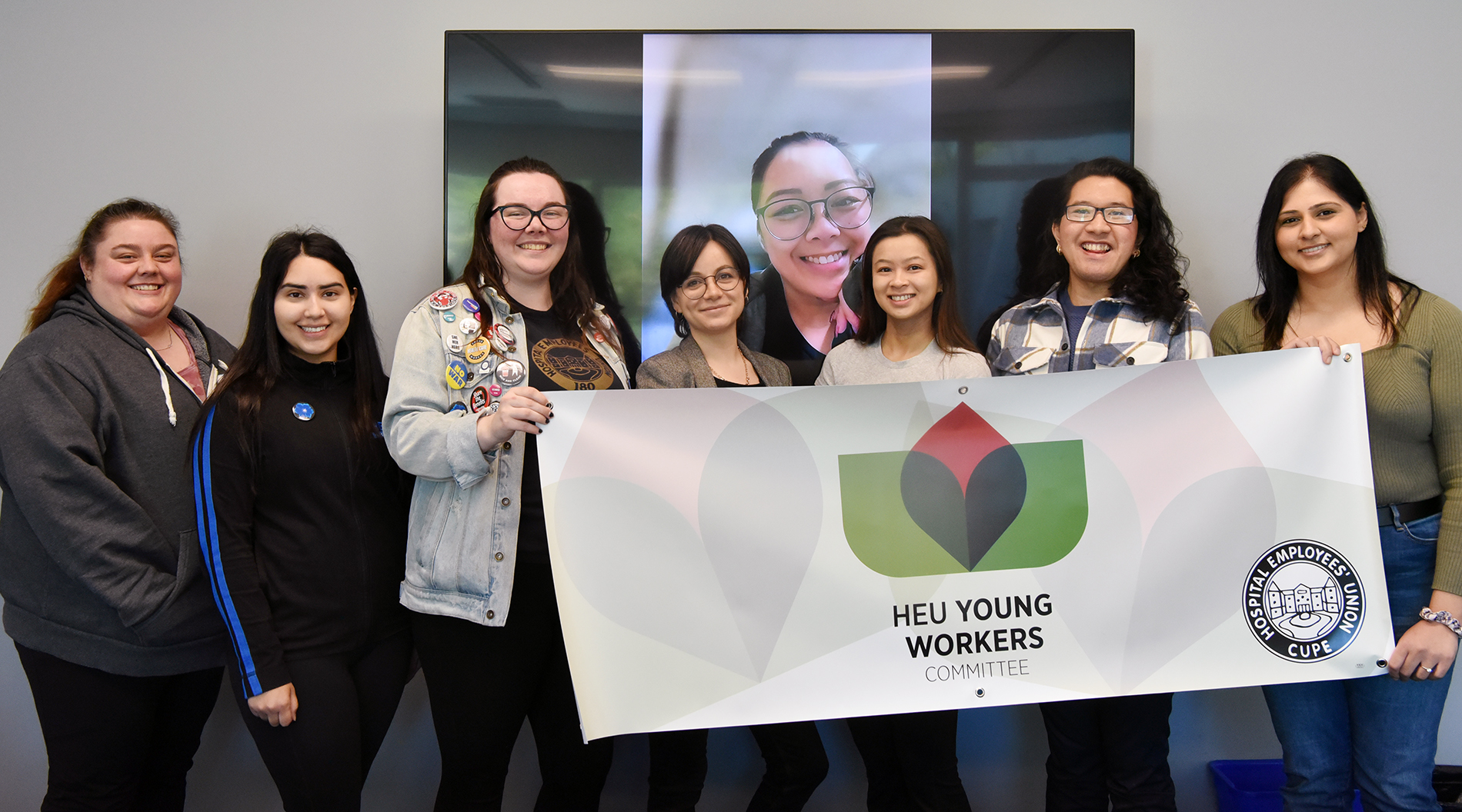 HEU Young Workers Committee members holding banner