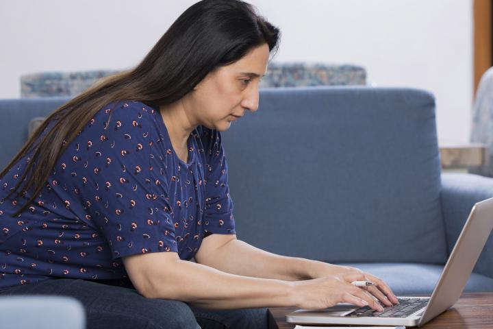 Woman filling out application on computer