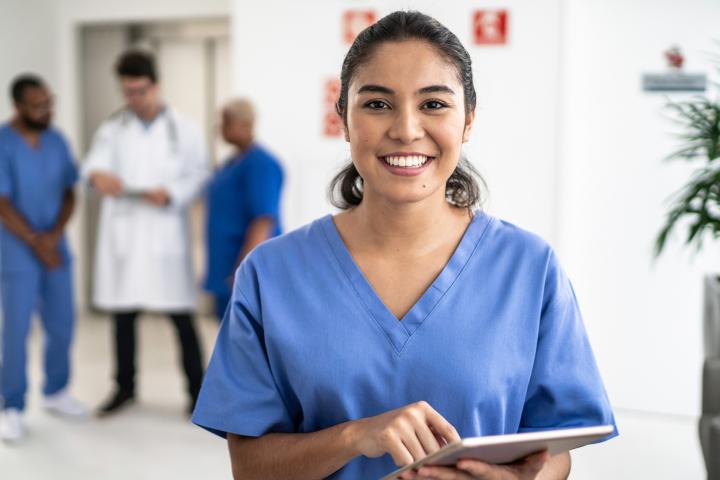 Smiling health care worker in blue scrubs