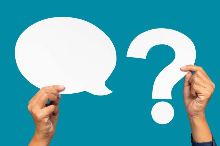 hands holding question mark and speech bubble