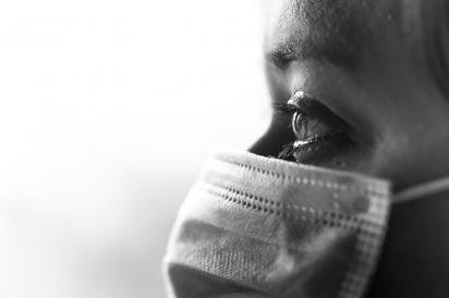 close-up side profile of nurses aide wearing a mask