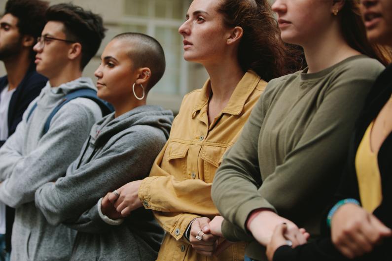 Conference attendees linking arms